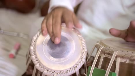 close up of man playing tabla drums