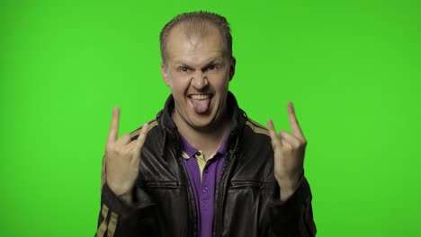 rocker man showing rock and roll sign, devil horns gesture, looking with crazy expression