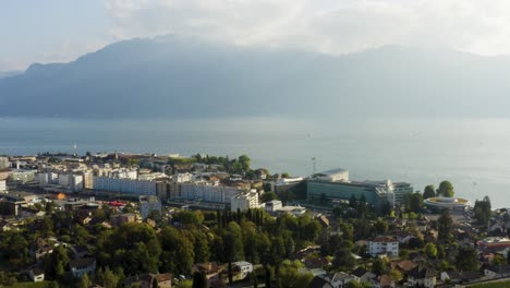 aerial shot above vevey, lake léman and the alps in the background vaud - switzerland