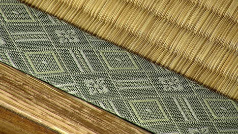 edge of tatami mat covered in fabric with woven pattern