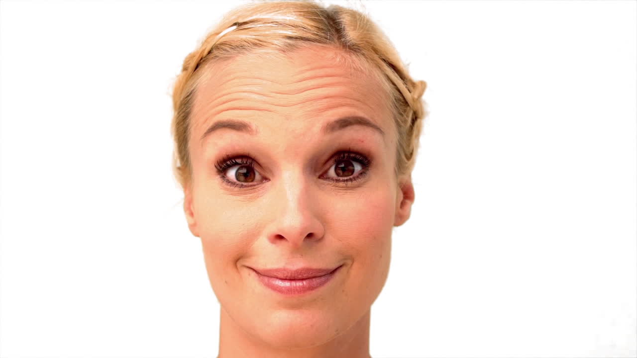Woman smiling and looking at the camera on white background