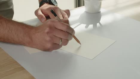 the designer draws a sketch with a pencil - the packaging design process