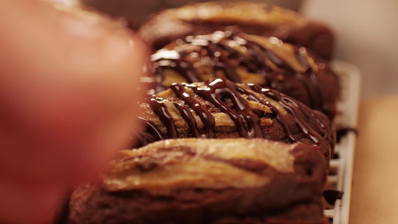 Fresh bake double chocolate banana artesian bread in bakery shop close-up. Artisan bread is making by skill bakers using natural and high-quality ingredients. Food with health and flavour benefits. Sweet breads for dessert and breakfast