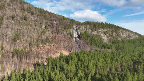 waterfall falling from high rocks of a mountain in norway