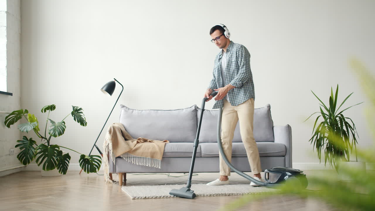 Man Cleaning House While Dancing to Music