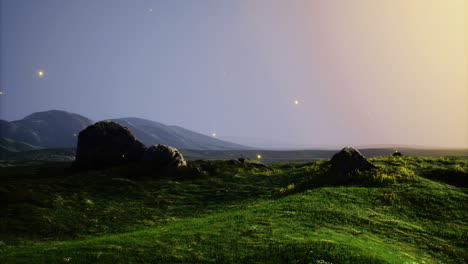 vibrant landscape showcasing rolling hills and rocky formations at dawn