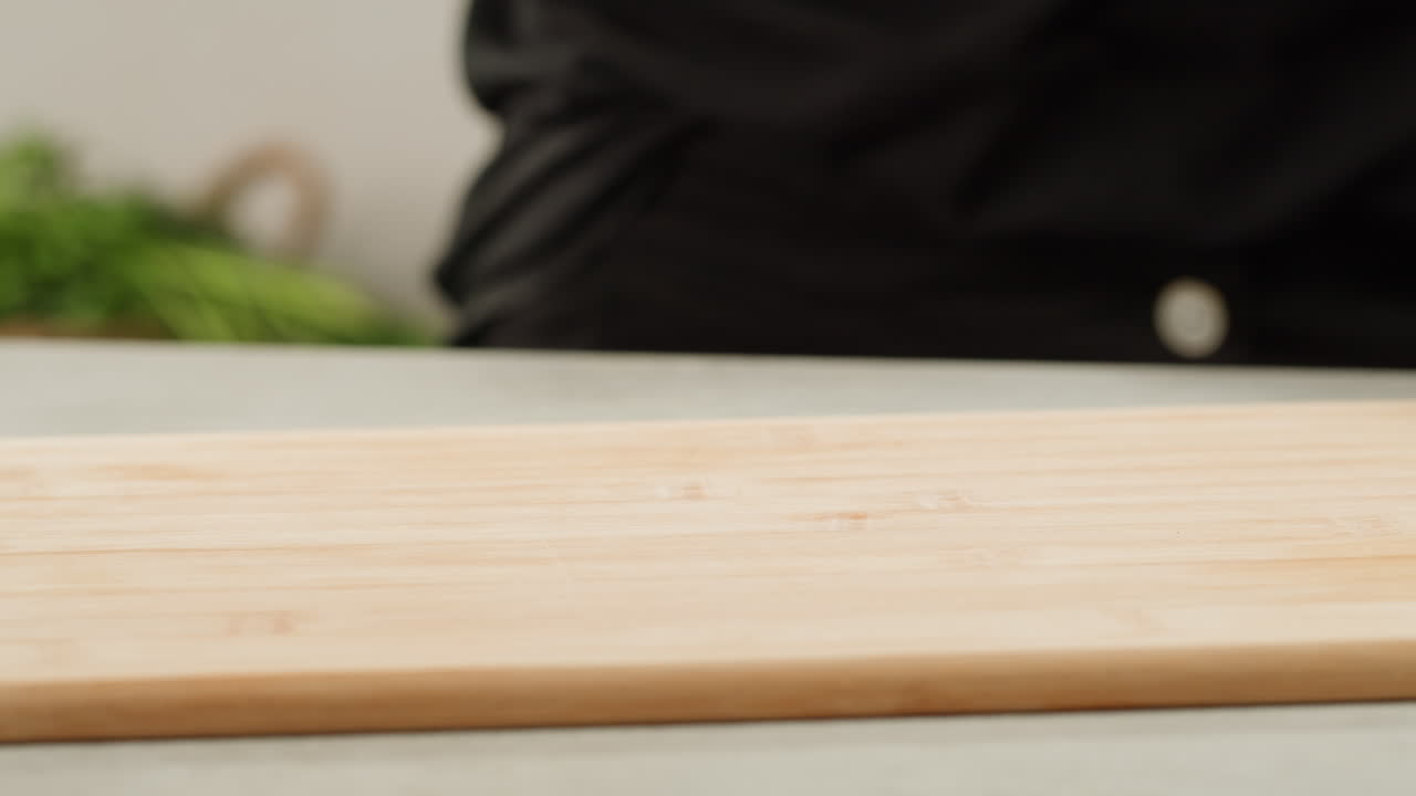 Cutting dill, chef cut dill with knife on a wooden board, close up at home, vitamin vegan greens.