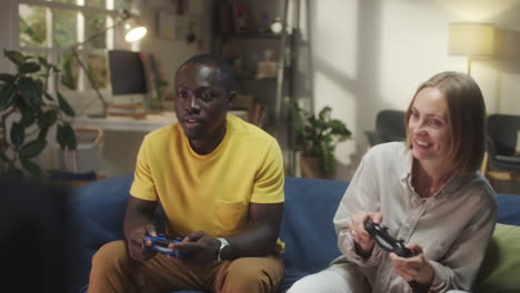 diverse couple playing console game