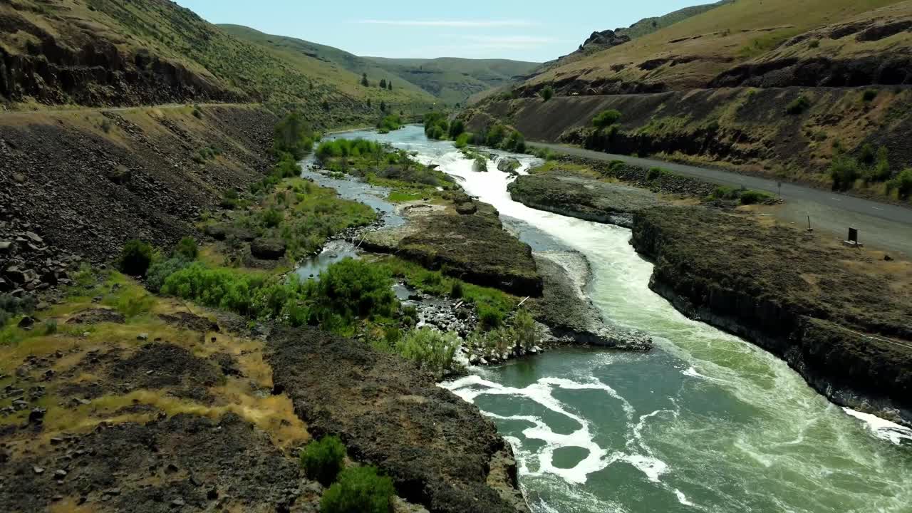 US, Oregon, Maupin, Sherar's Falls, 2025-05-08 - Drone view over the Deschutes River in spring with tribal fishing platforms over the river and a fish ladder. In north central Oregon