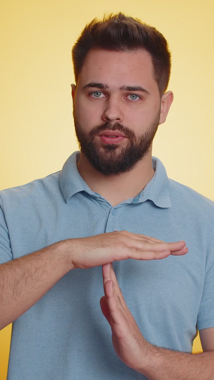 Tired serious upset caucasian man showing pause gesture stop sign time out relax break deadline