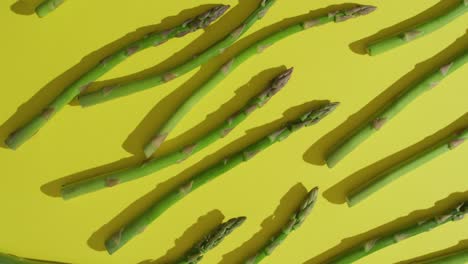 Video-of-close-up-of-fresh-asparagus-over-green-background