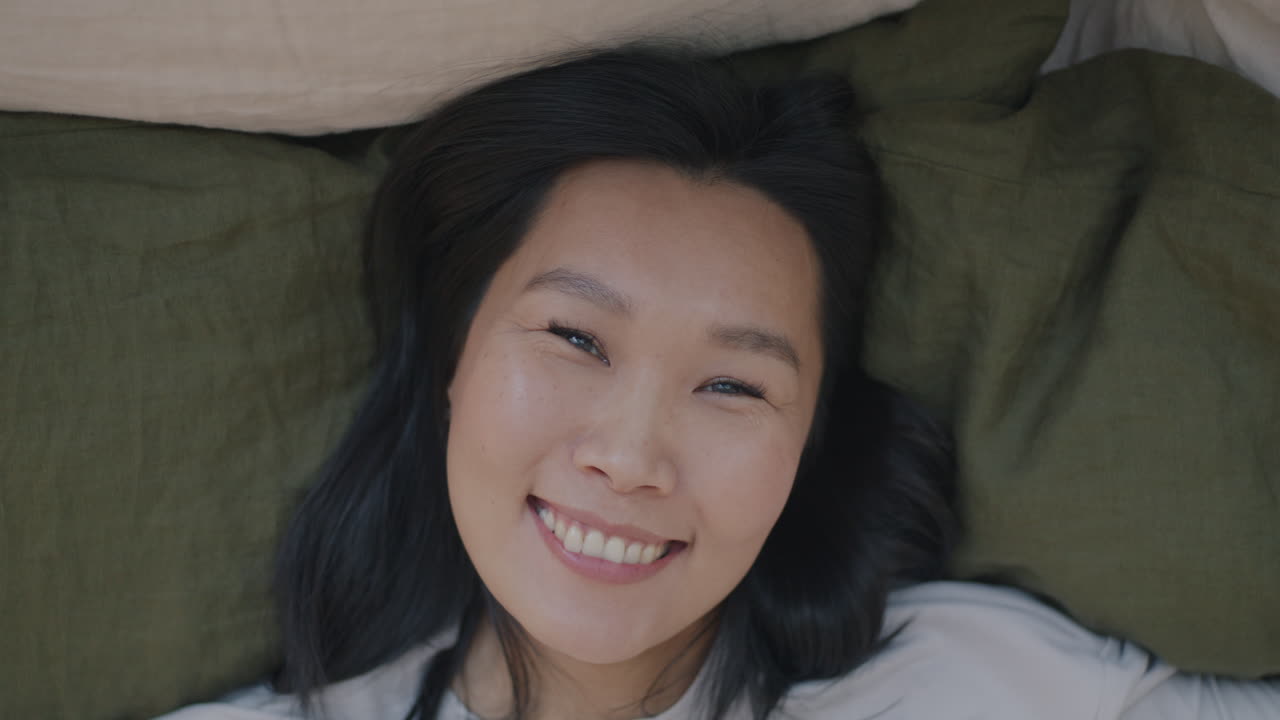 Happy Woman Lying in Bed