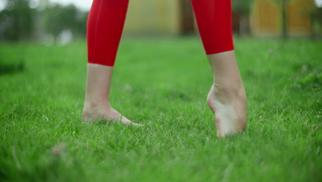 woman doing a balancing exercise outdoors
