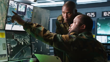 Army-specialists-looking-at-mission-case-file-and-equipment-screens