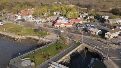 An-aerial-hyperlapse-of-the-coastal-roadway-in-Hingham,-MA-abutting-Hingham-Harbor