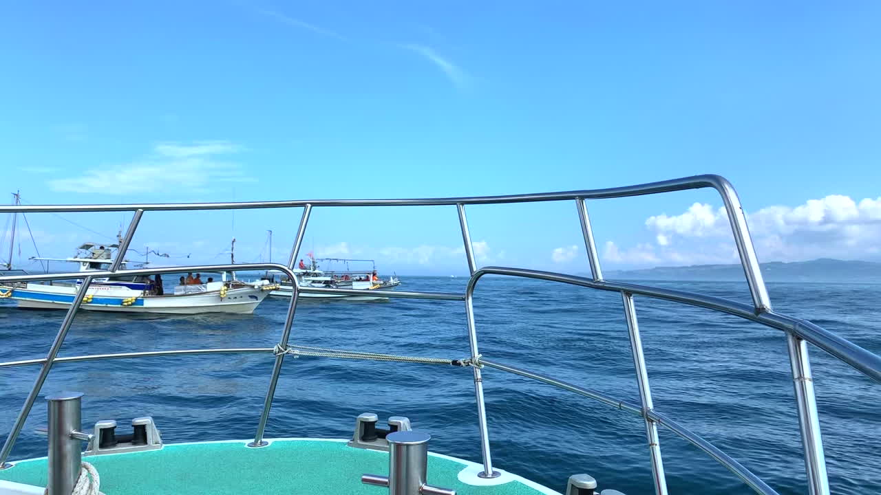 Ship shakes at high waves in front of a batch of ships