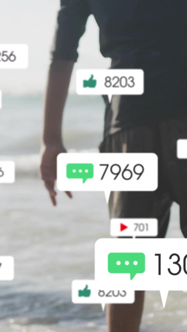 Vertical video: Girl wading surf and boy walking in, sparking social metric bubbles showing growth