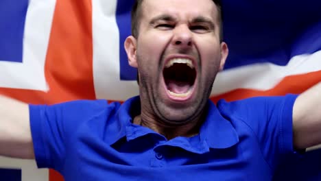 icelandic fan celebrates holding the flag of iceland in slow motion ,4k , high quality