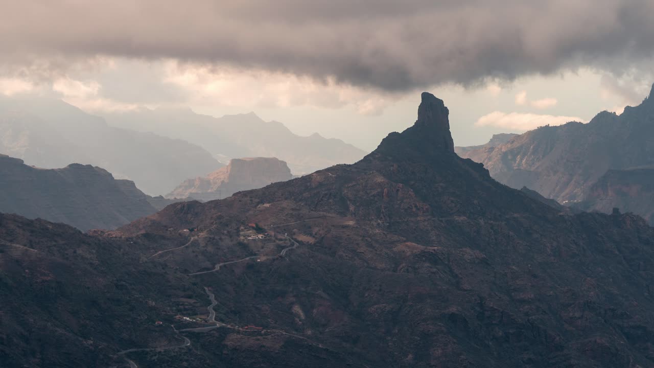 Epic timelapse of Roque Bentayga under shifting clouds in Gran Canaria. The rugged volcanic landscape creates a mystical and cinematic scene. Ideal for nature, travel, and adventure projects.