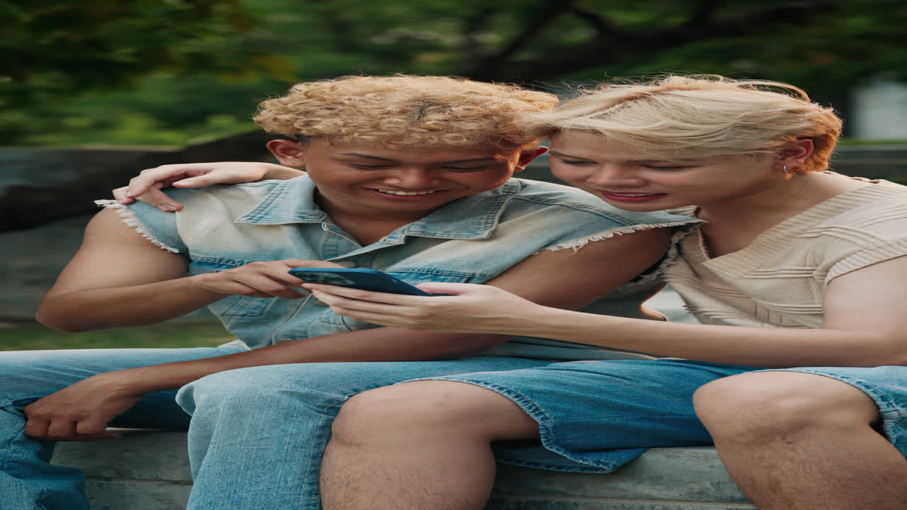 Two young people enjoying content on a mobile phone