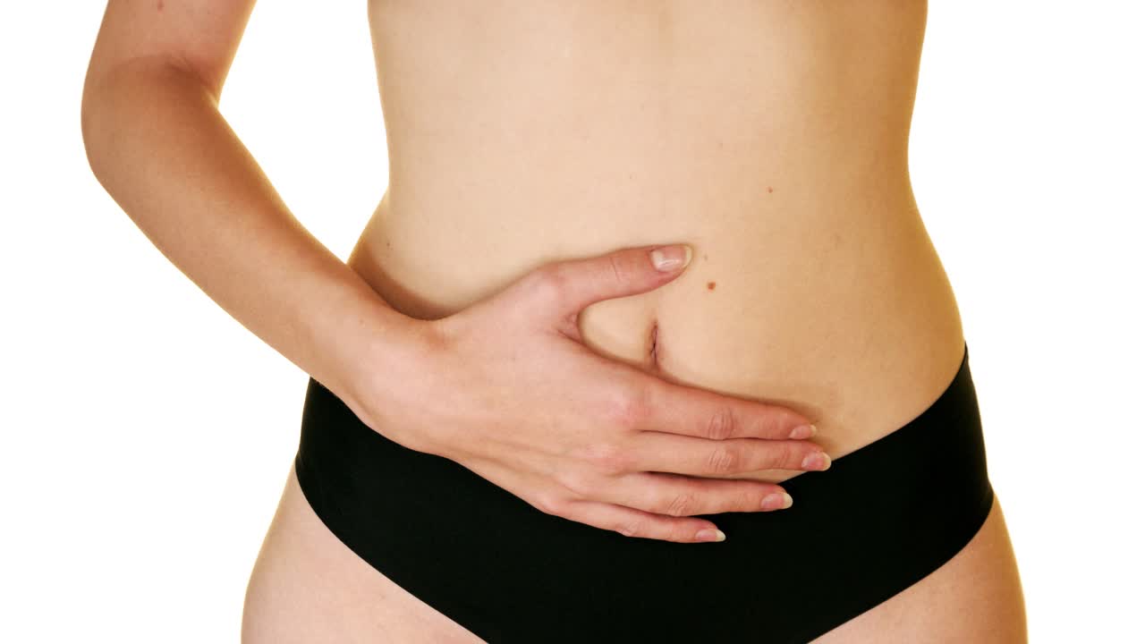 Woman putting her hand on her belly