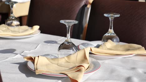 empty table setting with glasses and napkins at a restaurant