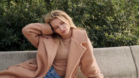 young woman resting on bench in the park.