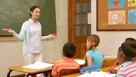 young pretty teacher having lesson to children