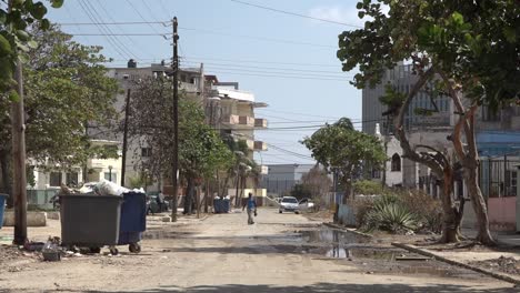 an older man crossing still wet streets of havana after hurricane irma hit.