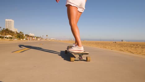 Pies-Femeninos-En-Zapatillas-Empujando-Mientras-Monta-Monopatín---ángulo-Bajo