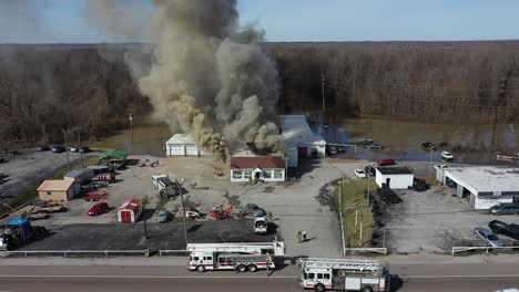 drone view pulling back to reveal more of an active fire with multiple agencies in attendance including local fire and police