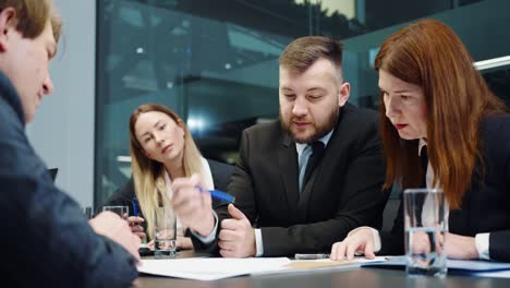 business people discussing financial report at meeting