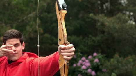 Man-shooting-bow-and-arrow