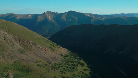 Aerial-cinematic-drone-early-morning-sunrise-hiking-trail-Grays-and-Torreys-14er-Peaks-Rocky-Mountains-Colorado-stunning-landscape-view-mid-summer-green-beautiful-snow-on-top-forward-pan-up-movement