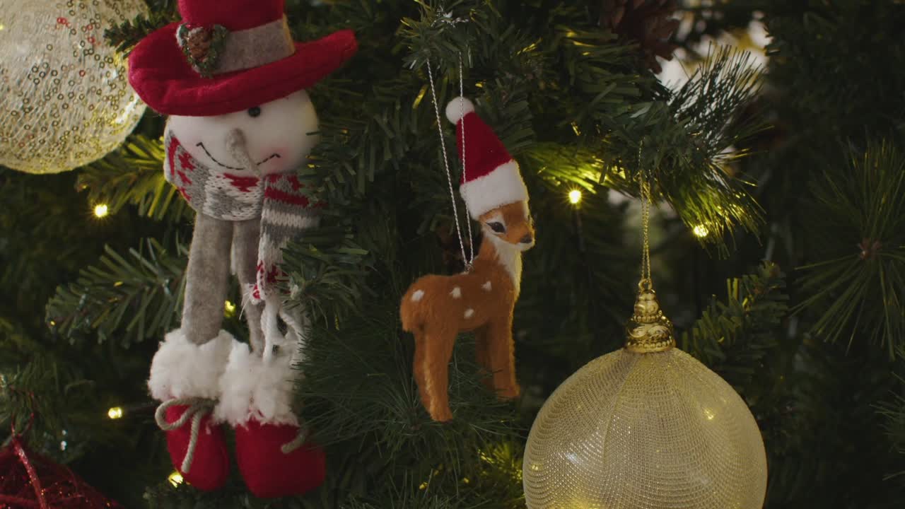 Charming festive tree glows with snowman and deer
