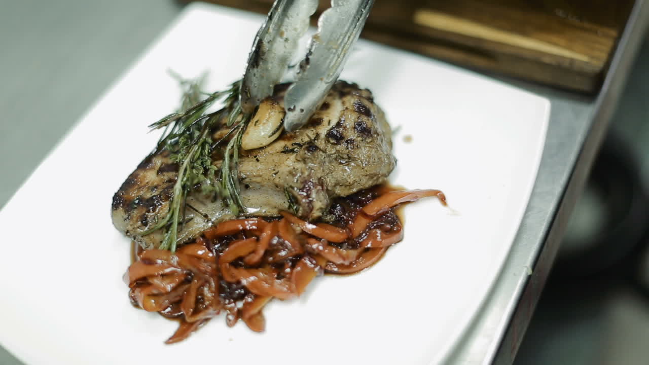 Prepared Meat Steak With Vegetables. Chef preparing delicious meal in the restaurant kitchen