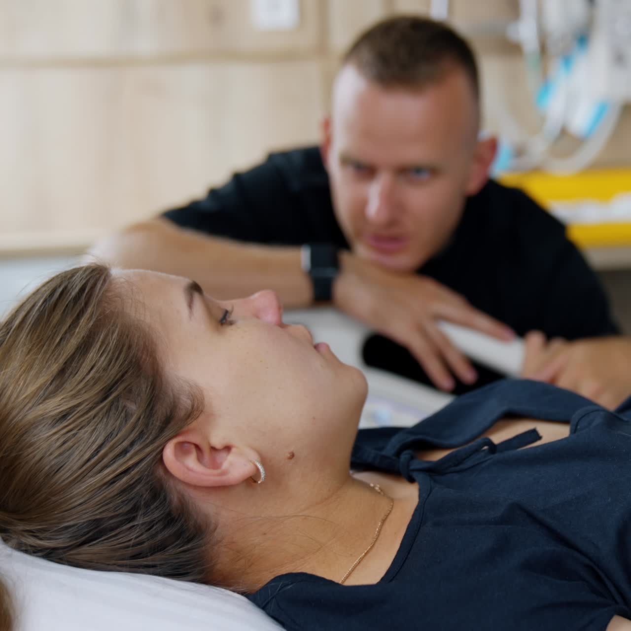 Doctor attending to a patient in a hospital bed