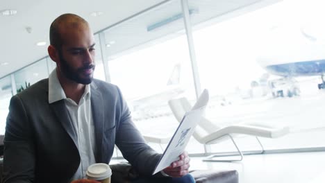 businessman having coffee while reading a document