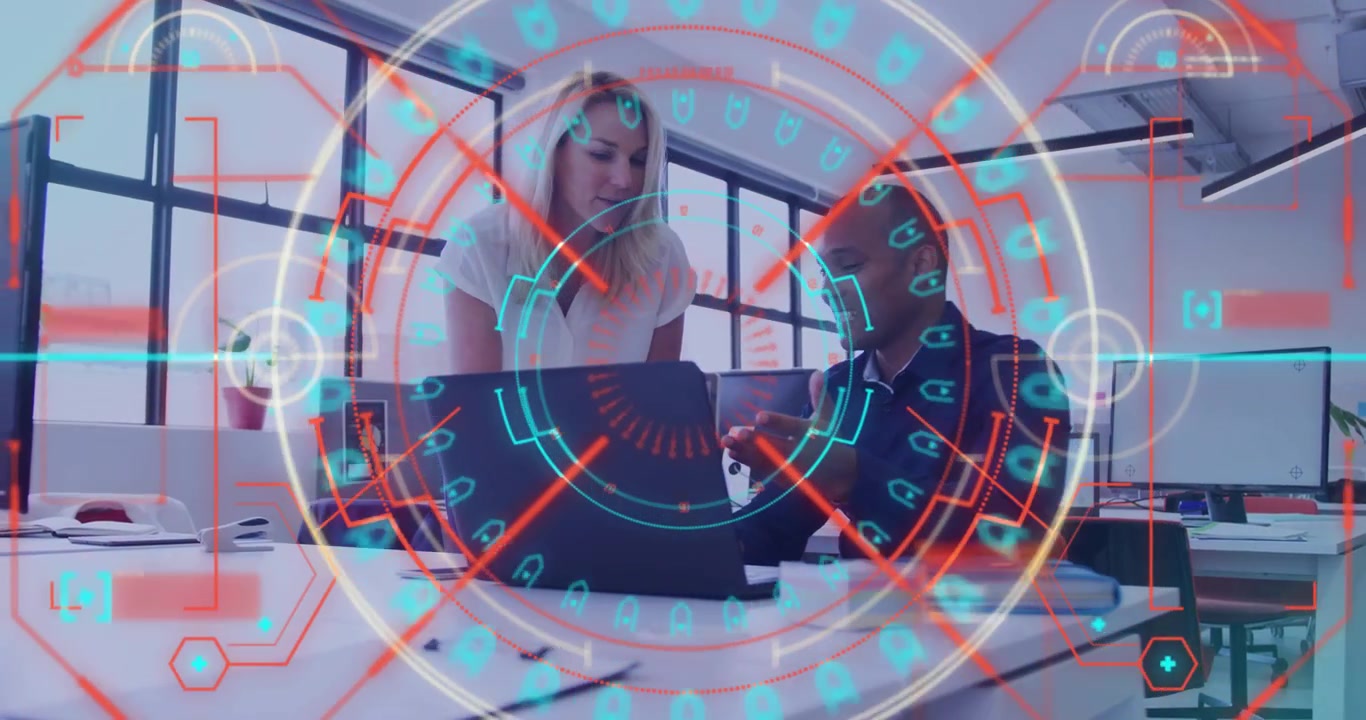 Coworkers leaning over laptop exchanging observations and exploring holographic business data rings