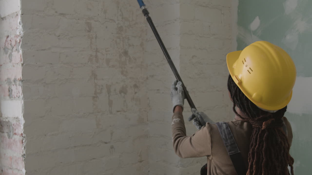 Woman painting a wall during renovation