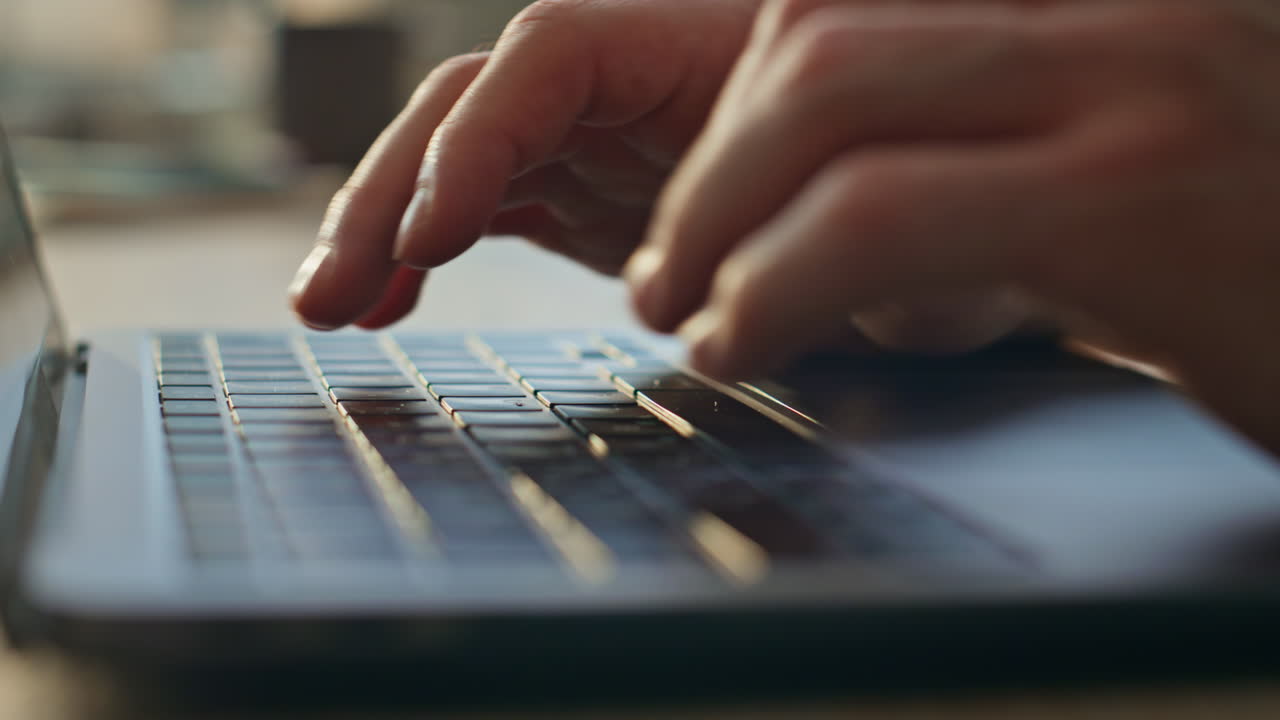 Man hands typing laptop keyboard searching internet in office desk close up.