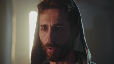 close-up portrait of a man wearing a hoodie