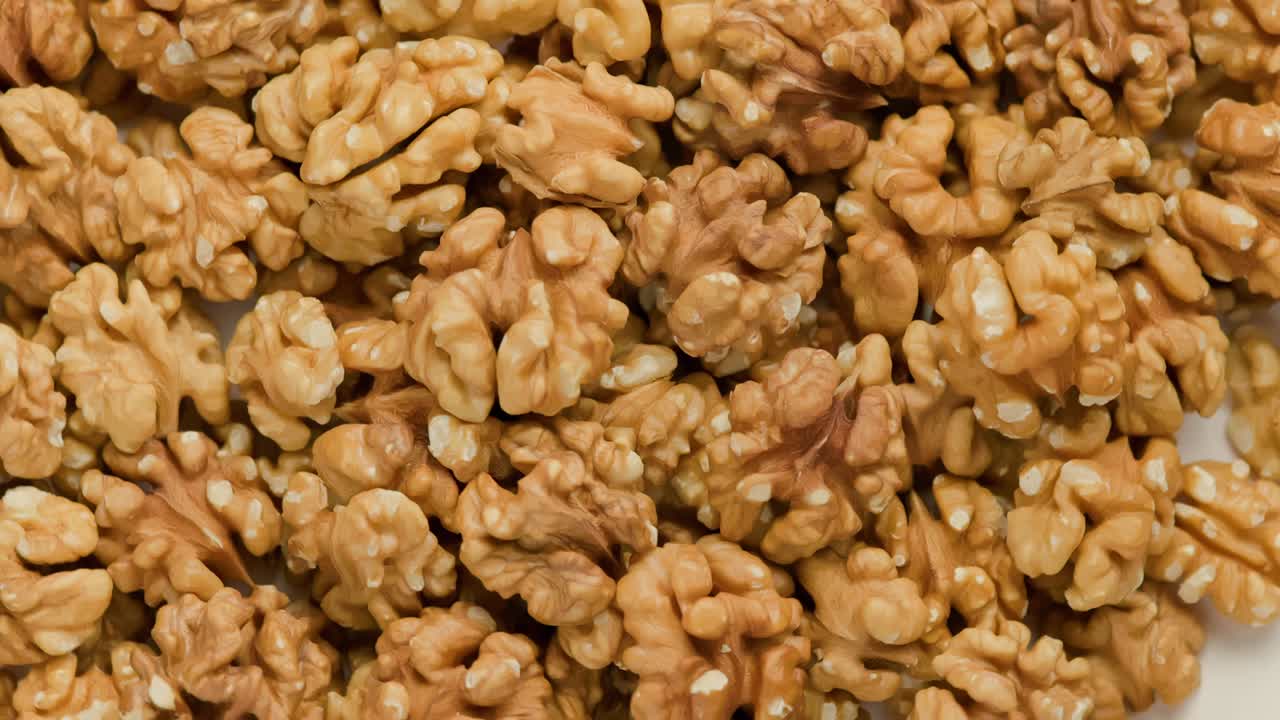 looped spinning walnuts without the shell close-up full frame background
