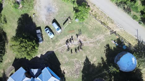 mountain bikers gather at a rural house