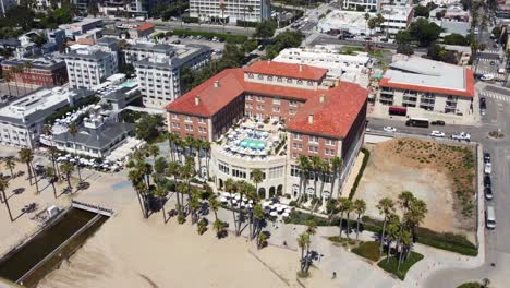 drone shot orbiting historic famous hotel on beach in los angeles