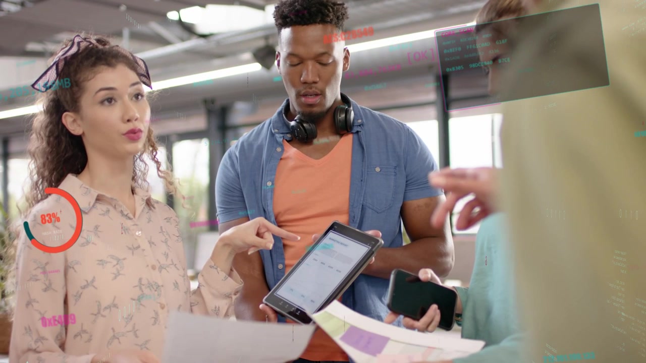 Design presenter tapping tablet, causing man holding tablet scrolling while team reviewing swatches