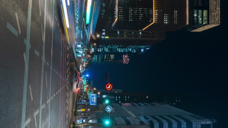 timelapse at night jong-ro road in seoul business downtown with vehicles moving both sides - vertical view