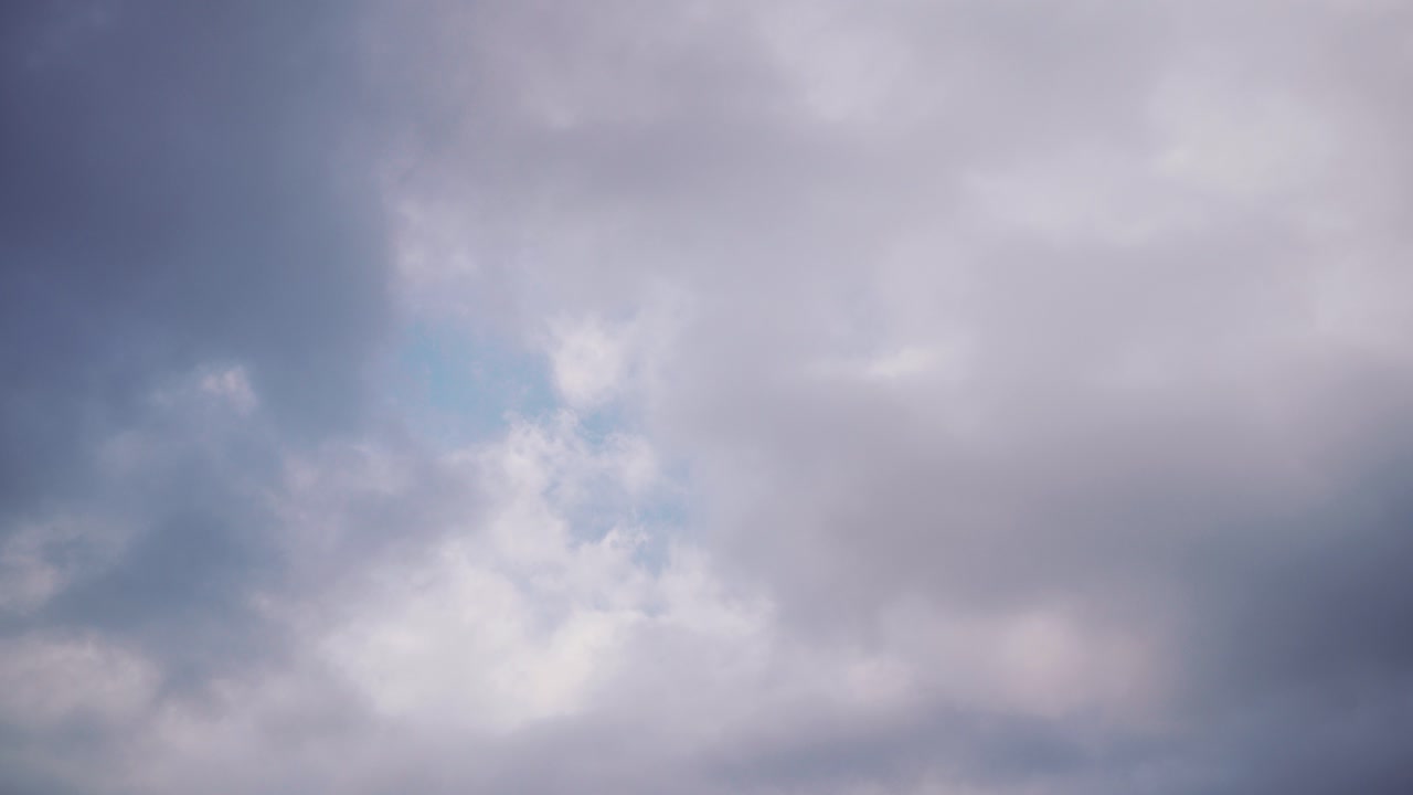 Cloudy sky with hints of blue, evoking tranquility and calmness