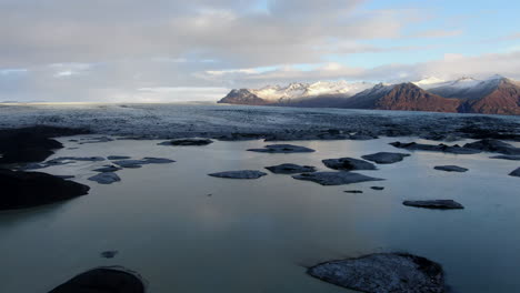 fantastic aerial shot over the haoldukvisl glacier and where you can see the beautiful lake created by the melting