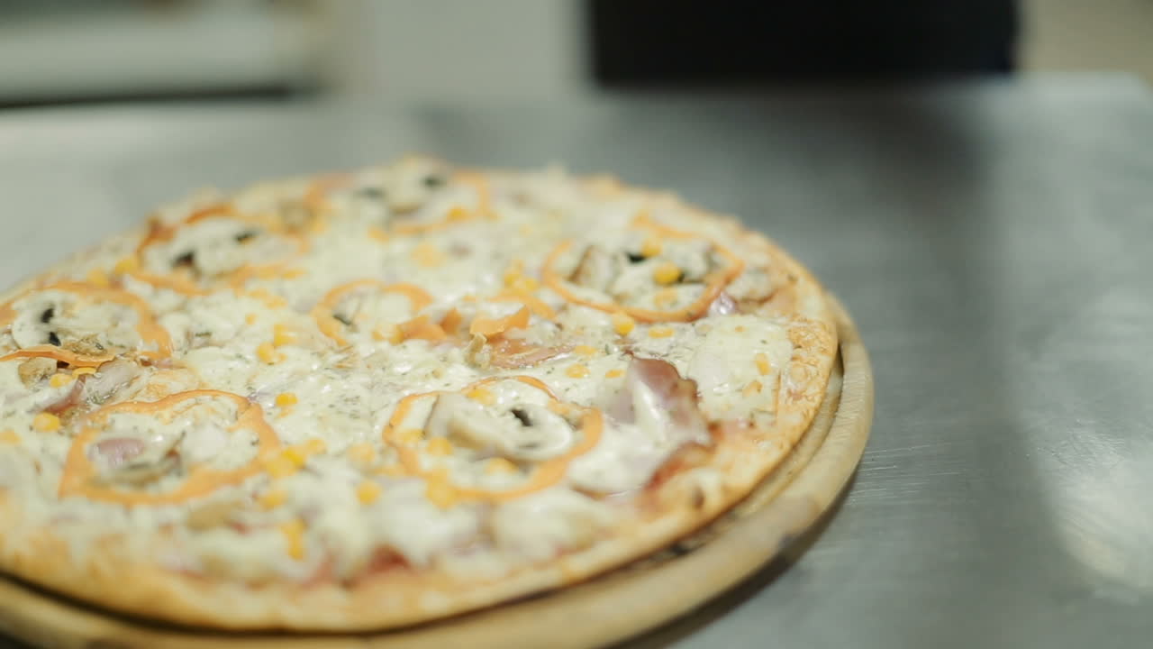 Step To Making Pizza By Chef. Chef giving finishing touch to pizza in kitchen